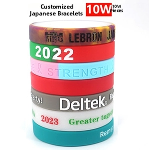 Macro detail of custom silicone wristbands with debossed text and various color patterns