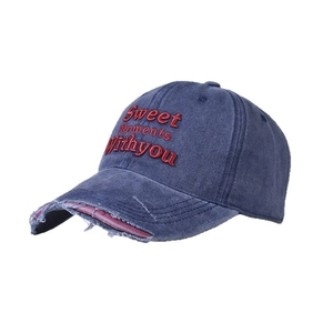 Close-up of vintage washed blue baseball cap featuring red Sweet Moment embroidery and distressed brim
