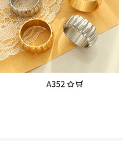 Detailed view of gold and silver textured rings on vintage lace and kraft paper background