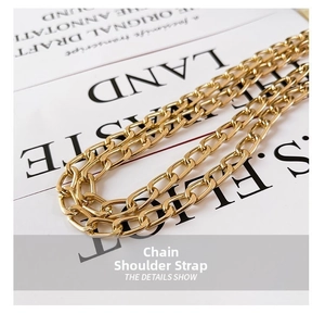 Detailed macro view of high-quality polished gold metal chain strap with mirror finish