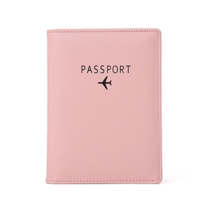 Pink RFID blocking leather passport holder with aircraft icon and embossed text