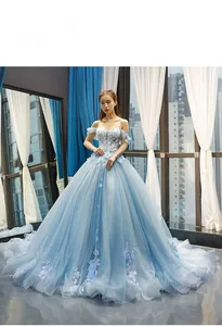 Detail of light blue off-shoulder gown with 3D floral embroidery and layered tulle