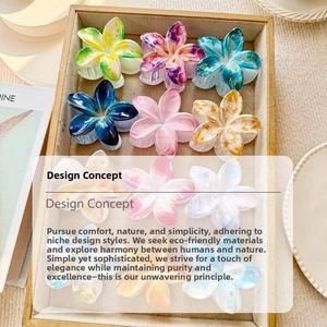 Flat lay of floral claw clips in assorted marble patterns and vibrant colors