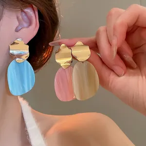 Minimalist irregular oval drop earrings with gold metal and marble acrylic textures