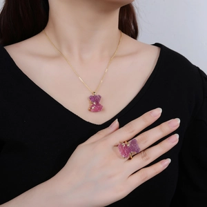 Fashionable crystal bear pendant necklace and ring set in pink purple and gold finish