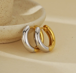 Detailed view of bicolor S925 silver hoop earrings with a modern tubular design