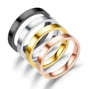 Close-up of minimalist flat rings in black, gold, rose gold and silver stainless steel