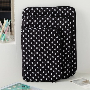 Black quilted fabric laptop sleeves with white heart patterns in small, medium, and large