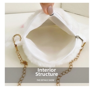 Close-up of the plush white bear-style mini bag interior with gold chain strap