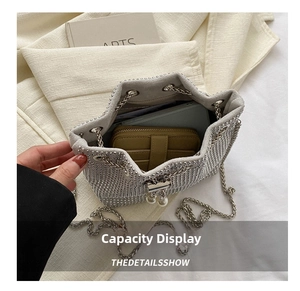 Detailed interior view of silver rhinestone bucket bag showing phone and wallet capacity