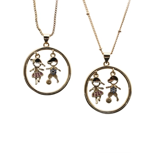 Detail of gold necklaces with boy and girl silhouettes featuring colorful crystal accents
