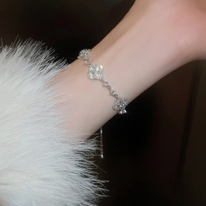 Detail of silver adjustable clover bracelet with sparkling cubic zirconia on a model wrist