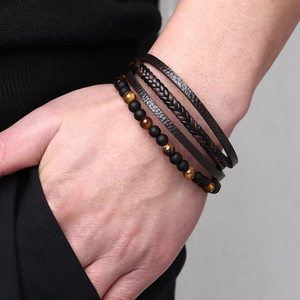 Men's three-piece bracelet set featuring tiger eye beads and black woven leather straps