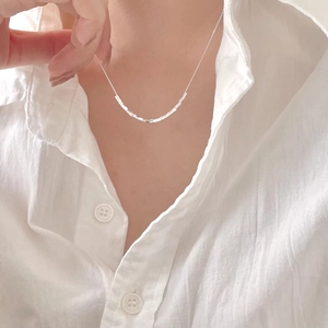 Minimalist 925 sterling silver cube chain necklace worn on collarbone over a white shirt