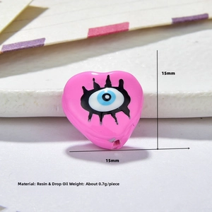 Detail view of 15mm pink heart resin Evil Eye bead showing precise dimensions and weight