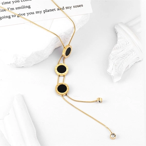 Geometric gold snake chain necklace with black Roman numeral pendants and zircon tassels