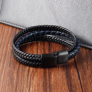Close-up of black and navy braided leather bracelet with matte black magnetic buckle
