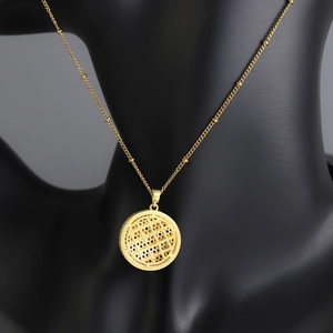 Elegant gold celestial planet pendant necklace with mesh design on black mannequin