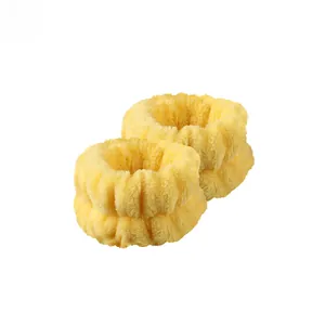 Close-up of yellow flannel wrist washbands with soft plush texture and elastic design