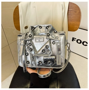 Detail of silver biker jacket crossbody bag with rhinestones and buckle accents
