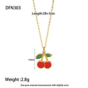 Detail view of gold elephant necklace with red cherry pendant, length 38 plus 5cm
