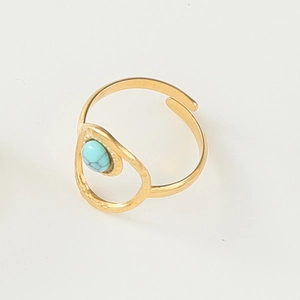 Detailed macro view of the irregular hammered gold ring with inlaid turquoise stone