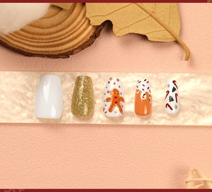 Close-up of Christmas themed coffin nails with gingerbread man and glitter patterns