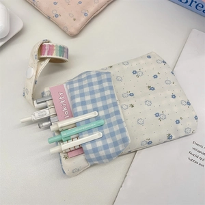 Detailed top view of a large floral nurse pocket pen pouch with stationery accessories