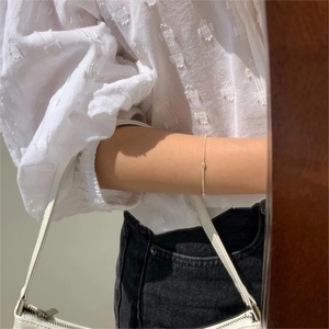 Minimalist S925 sterling silver olive bead bracelet styled on wrist with casual wear