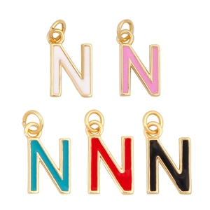 Detailed macro view of colorful enamel letter N charms with gold plating for necklaces