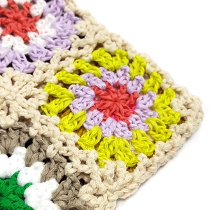 Close-up detail of multi-colored granny square crochet pattern with high-quality cotton stitching