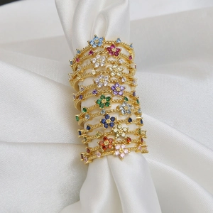 18k gold plated brass rings featuring colorful cubic zirconia flower stones set on white silk