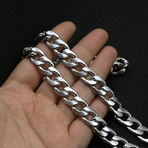 Detailed close-up of heavy silver cuban link chain with high-polished stainless steel finish