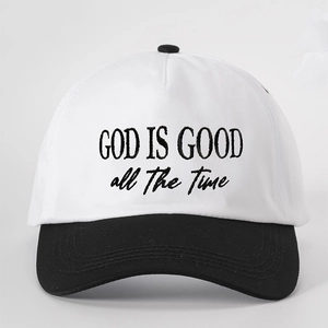 Detail of God Is Good embroidery on a black and white contrast trucker baseball cap
