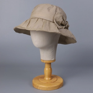 Detailed view of the elegant beige ramie sun hat with a large decorative bow