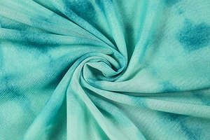 Detailed close-up of blue tie-dye breathable mesh fabric with soft pleated texture
