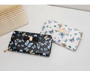 Close-up of elegant butterfly print PU leather wallets with bow and gold hardware