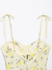 Close-up of floral print poplin top featuring adjustable tie shoulder straps and V-neckline