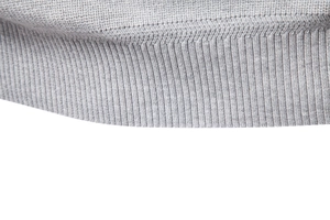 Detailed macro shot of grey knitted ribbed cuffs and high-quality stitching on the sweater