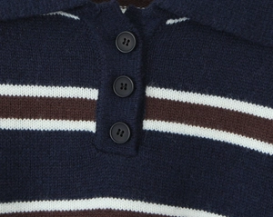 Detail of navy knit polo shirt featuring contrast stripes and classic three-button placket