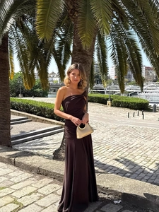 Elegant chocolate one-shoulder maxi dress with ruched details and side slit in city garden