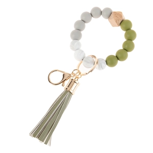 Detail of beaded keychain bracelet with silicone beads, wooden hex bead and PU tassel