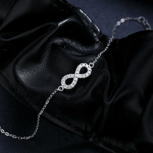 Elegant s925 silver Mobius bracelet with Moissanite stones on black leather background