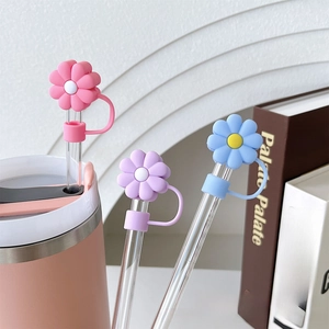 Detail of colorful flower silicone straw covers in pink, purple and blue for dust protection