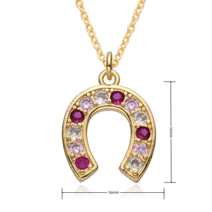 Detail shot of a 16mm gold horseshoe pendant necklace with colorful pavé gemstones