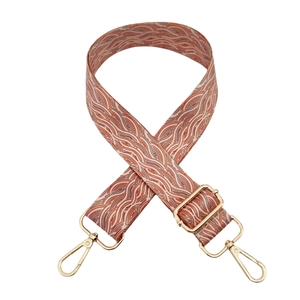 Ethnic style wave pattern fabric shoulder strap with gold metal hooks on white background