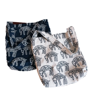 Artistic canvas tote bags with sheep embroidery pattern in navy and beige colors