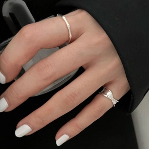 Detail view of 925 sterling silver rings with bamboo and layered irregular designs