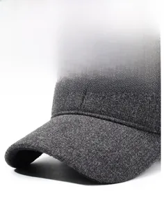 Detail of a dark gray wool baseball cap showing the sturdy brim and textured fabric