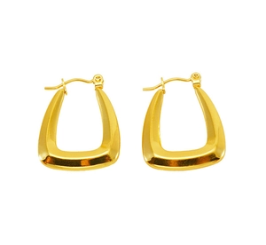 Close-up of golden geometric trapezoid hoop earrings with a high-polished mirror finish